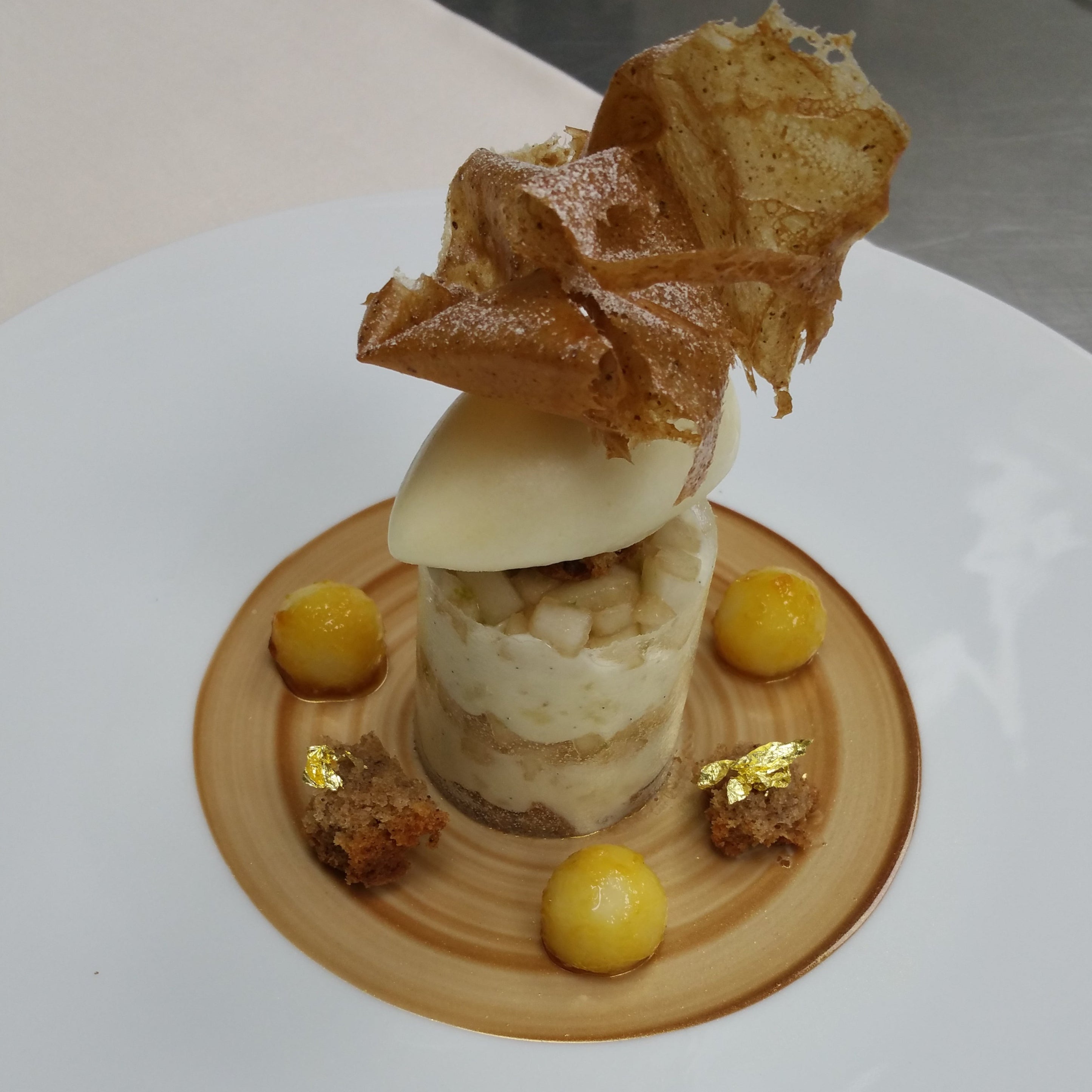 Delicate dessert presentation on a white plate with a focus on textures and colors. 

"The pear and it spiced cake"